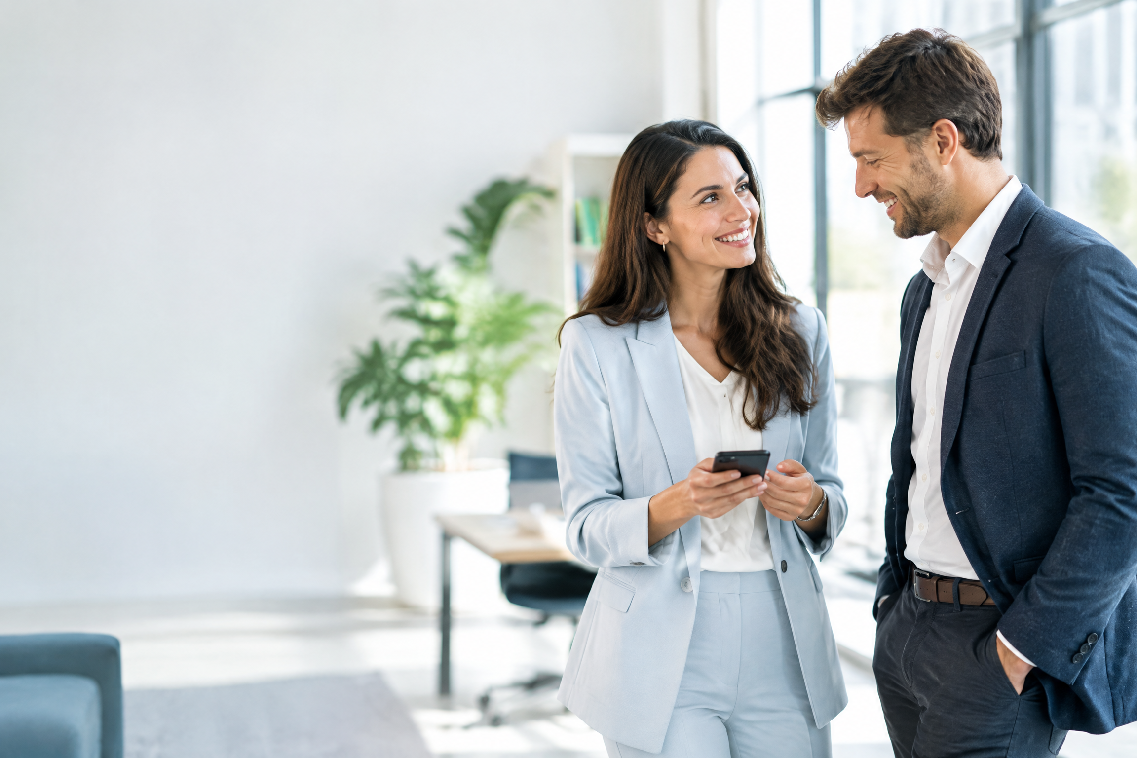 Two people share contact details with a smartphone